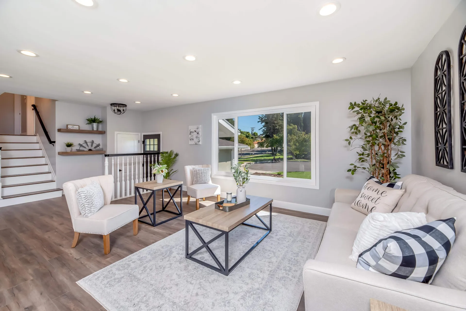 Bright open-concept remodeled living room with warm wood floors