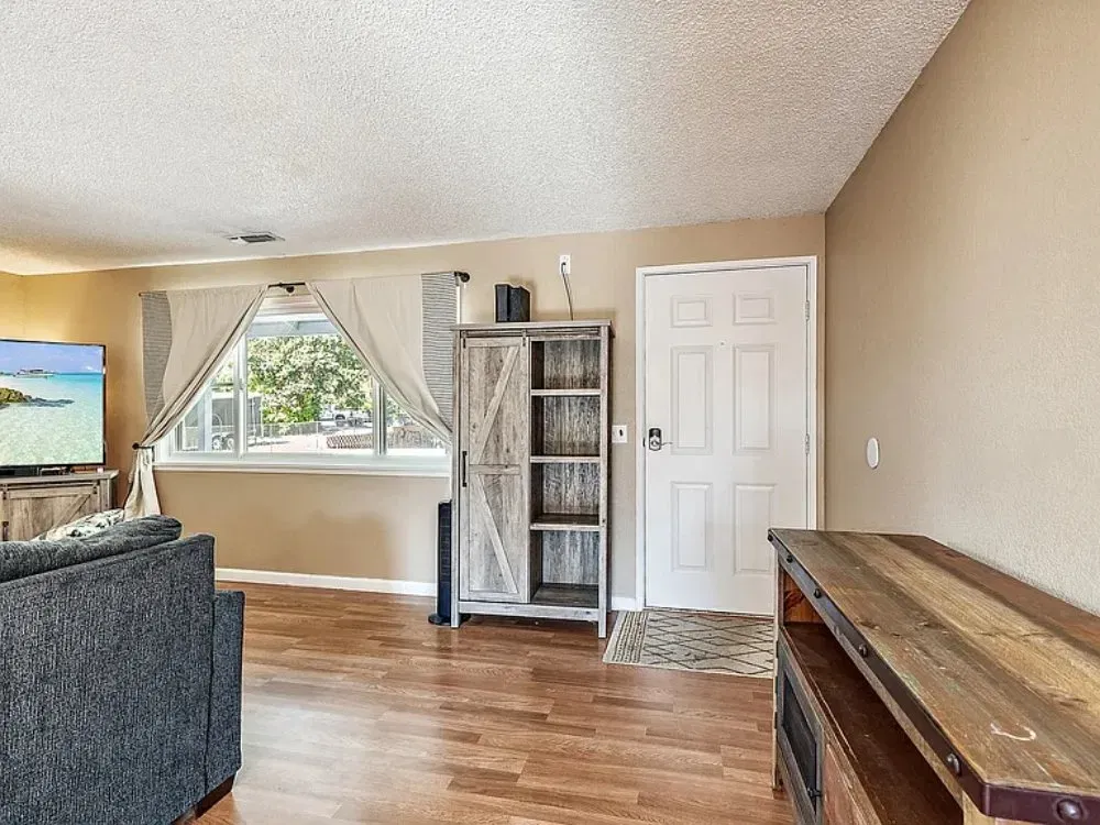 Bright living room with comfortable seating and hardwood-style floor